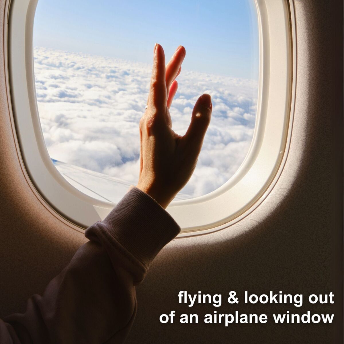 Album cover of flying & looking out of an airplane window